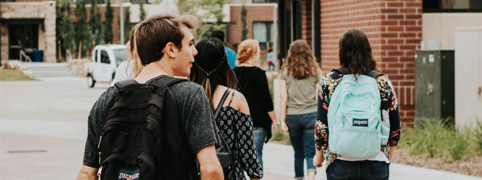 Students walking together between campus housing buildings